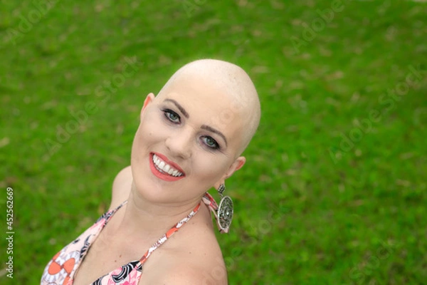 Obraz Beautiful portrait Woman, beautiful and strong . Happy and smiling, on the ranch with a lot of sensuality. Smiling and looking steady and steady. Bald and hairless from breast cancer.