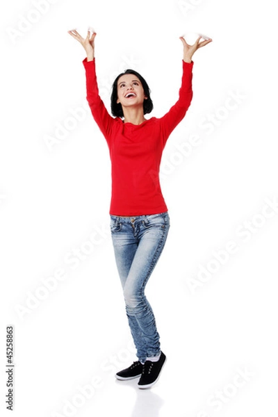 Obraz Woman  is holding something abstract above her head.