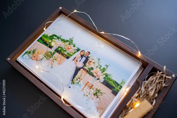 Fototapeta wedding photos and flash drive in box. beautiful return of result of photo shoot