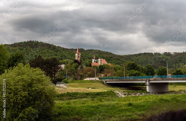 Fototapeta blue bridge over the river and the tower of the monastery