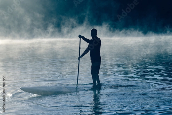 Fototapeta Man balancing on sup board