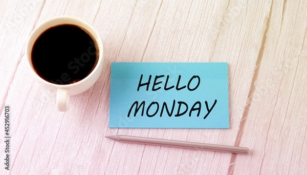 Fototapeta HELLO MONDAY text on the blue sticker with cofee and pen