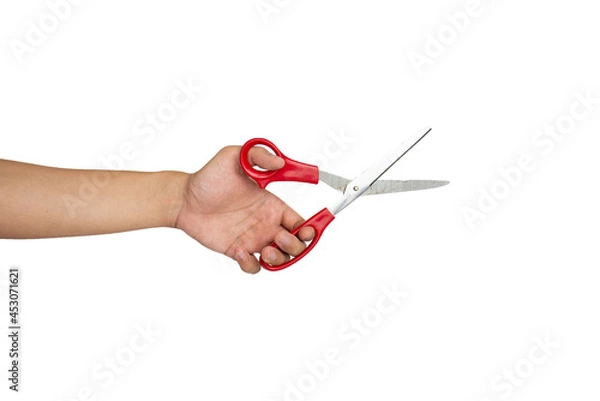 Fototapeta Close up of hand cutting using scissors isolated with white background