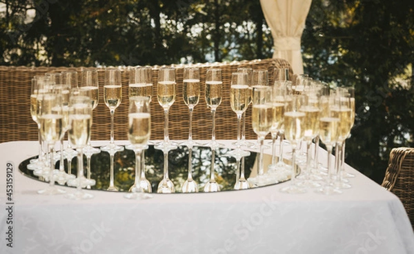 Fototapeta glasses with champagne on the table outdoors, wedding buffet