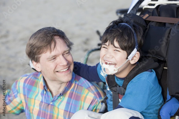Obraz Father enjoying  beach with disabled son