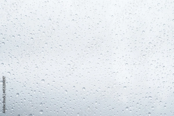 Fototapeta Rain drops and dew. water drops on a gray car roof after stopped raining , selective focus waterproof surface. soft focus. Leave space for writing text background.