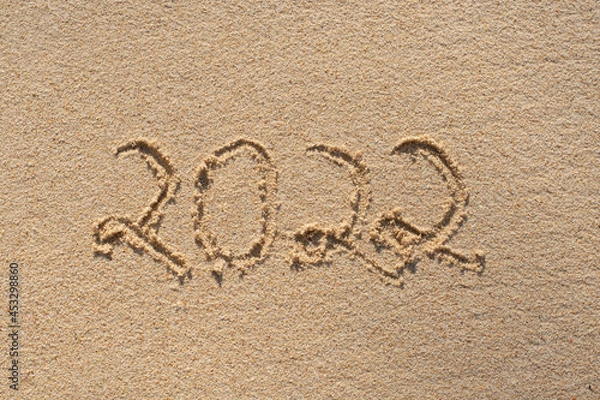 Fototapeta new year 2022 . happy new year number written in the beach sand