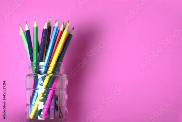 Obraz Colored pencils on glass on a pink background
