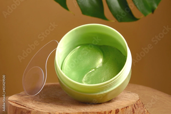 Fototapeta green eye patches to reduce puffiness and bruising under the eyes.   the concept of self-care