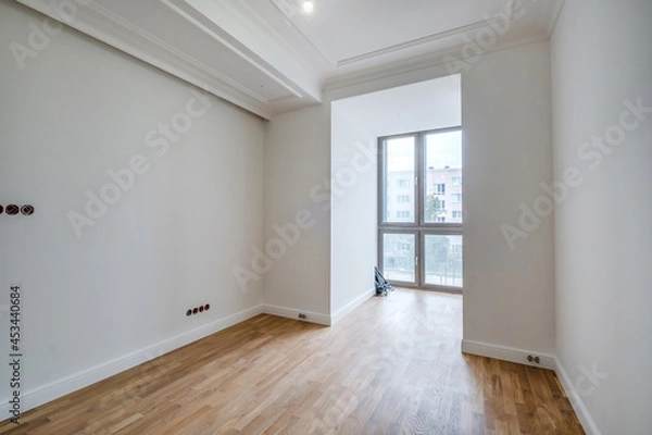 Fototapeta empty white room with repair and without furniture with panoramic windows