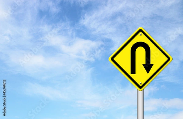Fototapeta Yellow warning sign u-turn roadsign with blue sky background