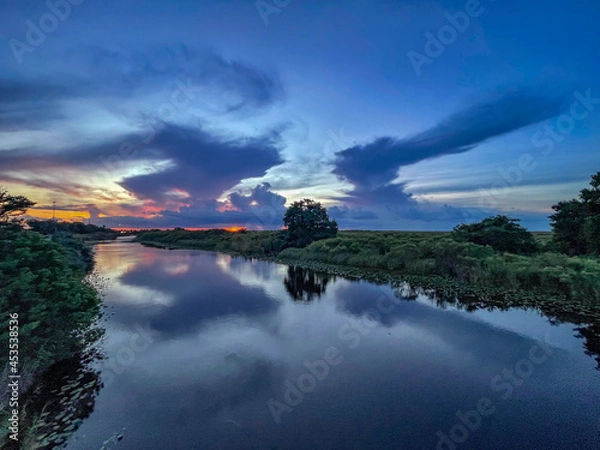 Obraz Swamp sunset and hurricane clouds