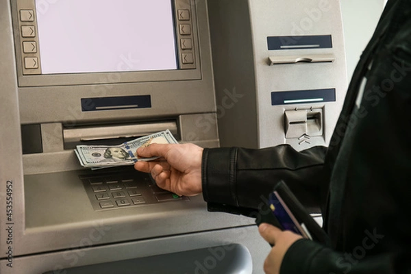 Obraz Man withdrawing money from ATM