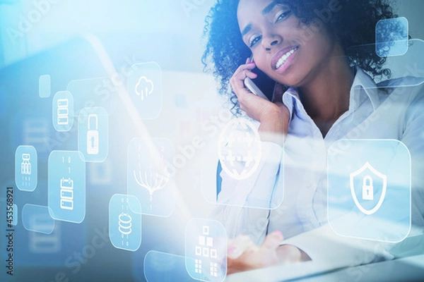 Fototapeta African American businesswoman wearing white shirt is talking on