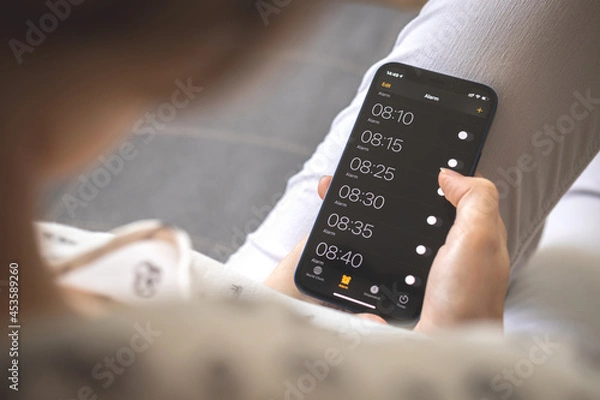 Obraz Alarm on mobile phone for morning wake up, mobile screen with alarm clocks close-up