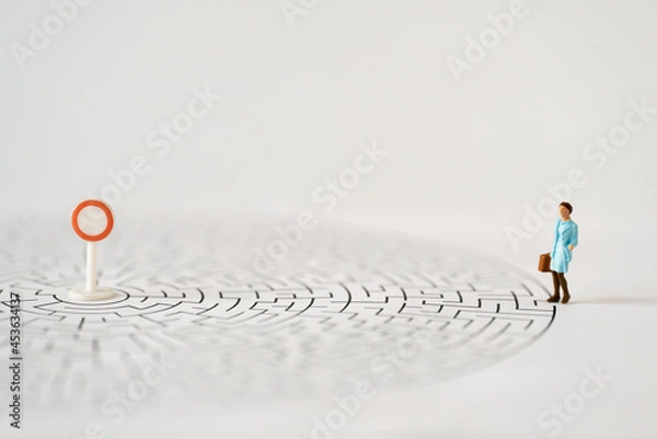 Fototapeta Miniature Business people office woman stand entrance of maze thinking business plan how to solve problem using for Accounting Financial Banking business growth development and Commerce Strategy Plan