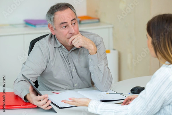 Fototapeta sales representative gives a handshake to female customer