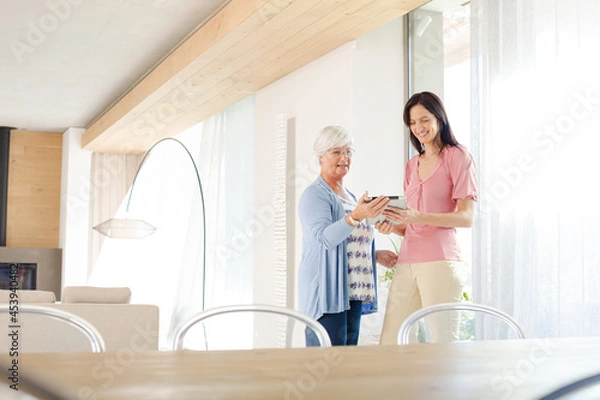 Obraz Mother and daughter posing with tablet computer