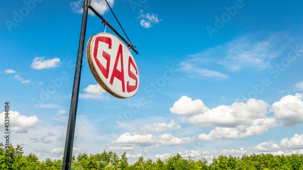 Fototapeta Retro GAS sign against beautiful blue sky with  light clouds. concept, background and copy space.