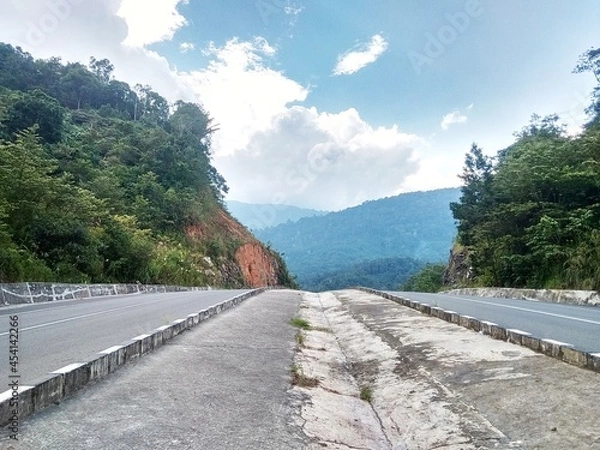 Fototapeta the appearance of two highways with a background of mountains and blue sky