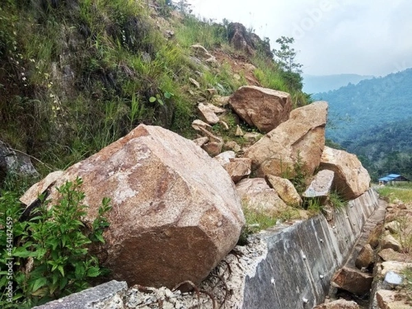 Fototapeta Pile of boulders on the side of the highway in a mountainous hill area