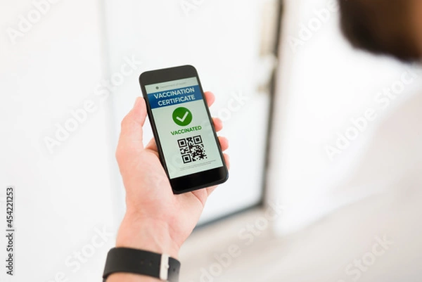 Obraz Young man checking his vaccine certificate