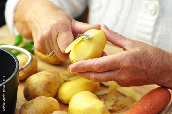 Obraz Starsza kobieta przygotowuje obiad