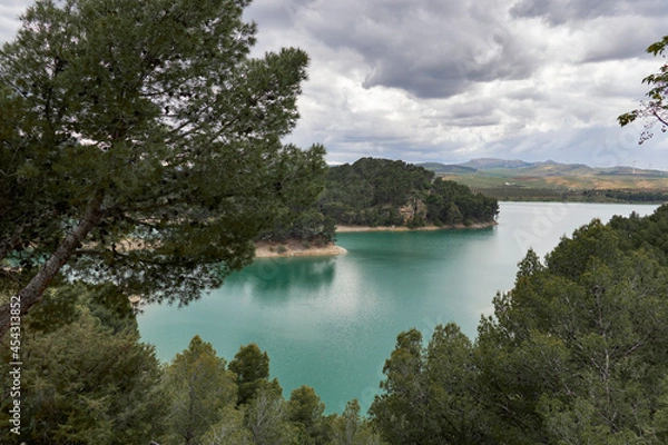 Fototapeta water reserves in the Guadalteba reservoir surrounded by pine trees in Malaga. Spain