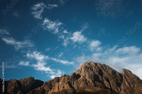 Obraz Jagged mountain peaks and big sky with clouds