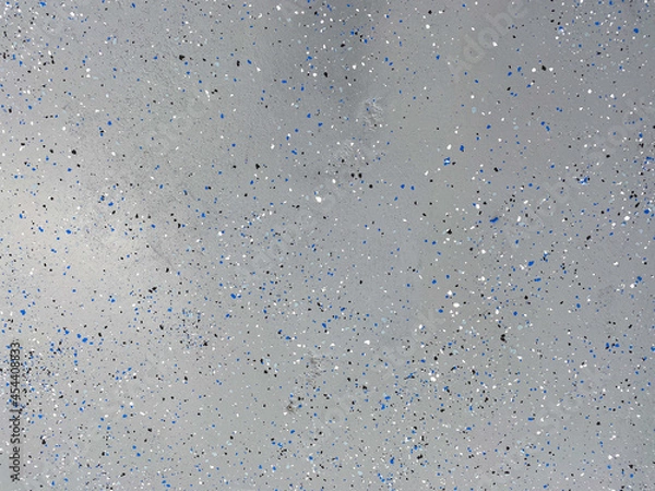 Obraz A freshly painted with a gray epoxy finish sprinkled with blue, black and white plastic chips.