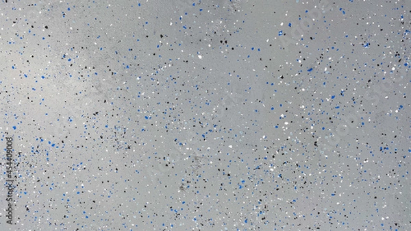Obraz A freshly painted with a gray epoxy finish sprinkled with blue, black and white plastic chips.