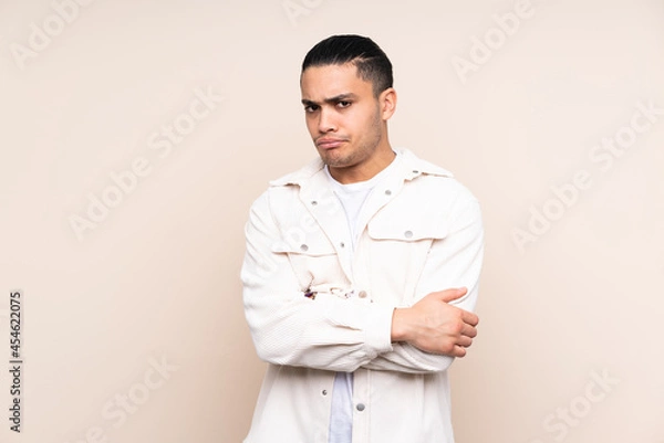 Fototapeta Asian handsome man over isolated background feeling upset