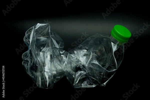 Fototapeta twisted plastic bottle isolated on black background