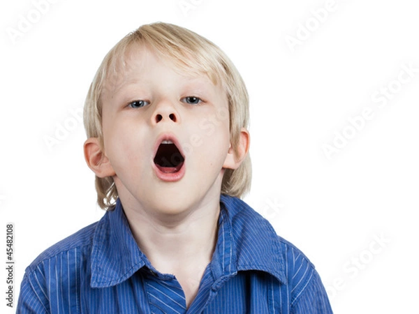 Obraz Tired cute young boy yawning.
