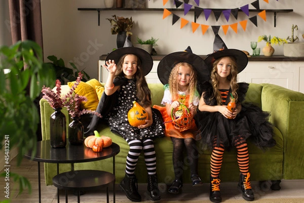 Obraz children in halloween costumes with pumpkin fooled on holiday