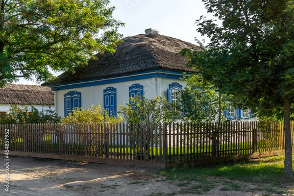 Obraz Typical middle class Cossack house. Whitewashed adobe walls, shuttered windows and a reed roof