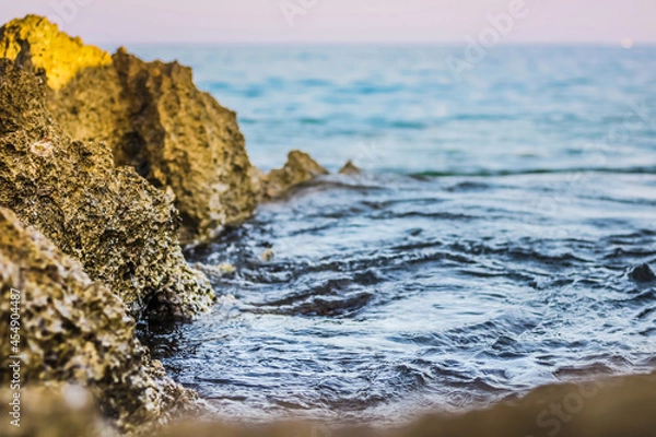 Obraz Stone in sea with wave on sunset