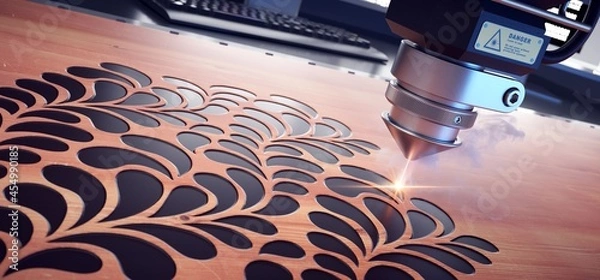 Obraz Laser cutter close up, cutting flower patterns on a wooden board. 