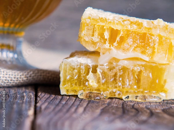 Fototapeta bee honeycomb with honey close-up on an old wooden table