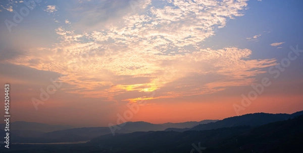 Fototapeta Colorful sunset and sunrise with clouds.Blue and orange color of nature.Many white clouds in the blue sky.The weather is clear today.sunset in the clouds.The sky is twilight.