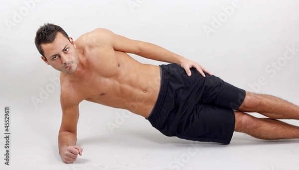 Fototapeta Mann macht seitliche Liegestützen
