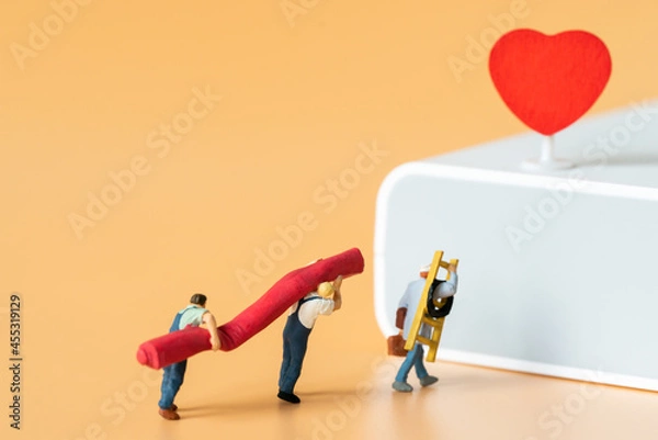 Obraz Miniature people Labor Worker walking carry ladder and red carpet for decorate stage with red heart using as special event making service business or Valentine day 14 February Lovely Happy Family idea