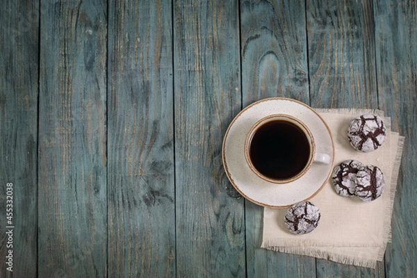 Fototapeta Cup of coffee with cookies on a wooden table, top view, background, copy space, breakfast.

