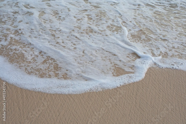 Obraz Beach sand with foamy waves background.