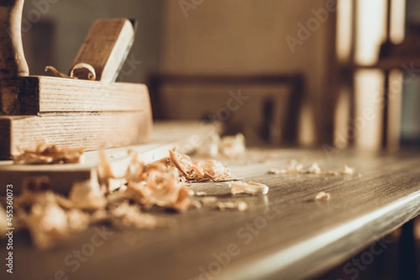 Fototapeta Plane jointer carpenter or joiner tool and wood shavings. Woodworking tools on wooden table