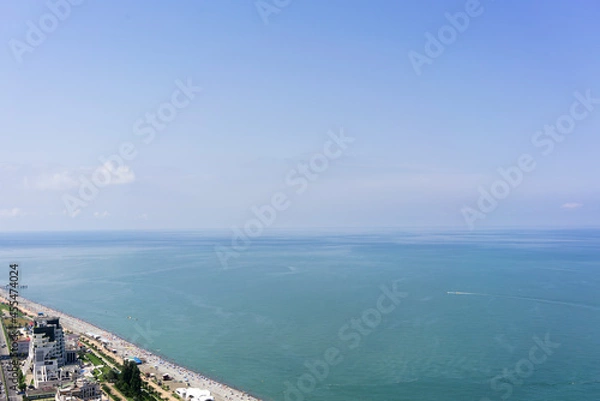 Fototapeta Top view of the coastal beach, blue sea and sky. Summer vacation by the sea