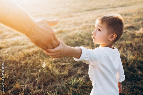 Fototapeta father holds out his hand to the child, trust family concept