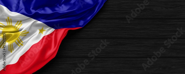 Obraz Close Up of Philippines flag on the black wooden background 3D render
