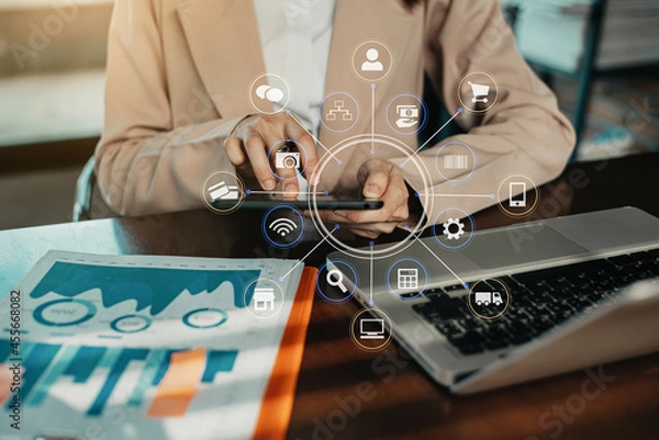 Fototapeta Business women hand working with tablet and laptop computer with documents on office desk.