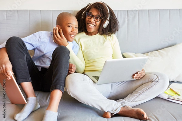 Obraz Mother and son on the sofa at home using a laptop